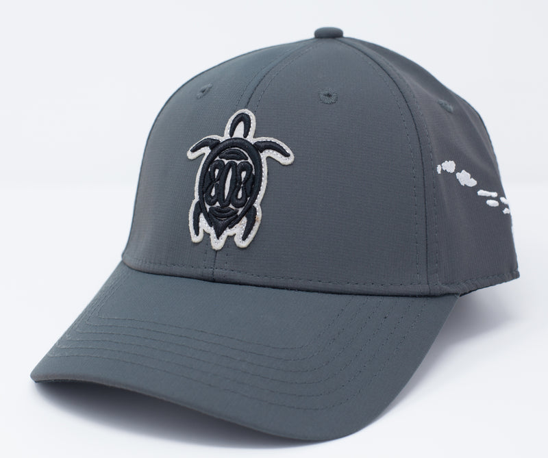 Gray colored sport material baseball cap with a turtle embroidery on the center front. Uses a buckle Closure.