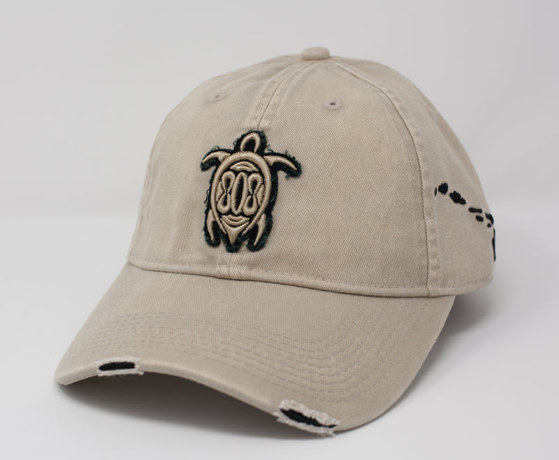 Tan vintage distressed dad cap. Turtle with 808 embroidered on front and Hawaiian islands on left side.
